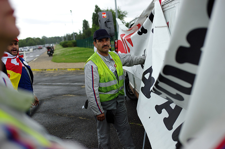 Week in business: A worker from PSA Peugeot Citroen demonstrates in Aulnay-sous-Bois