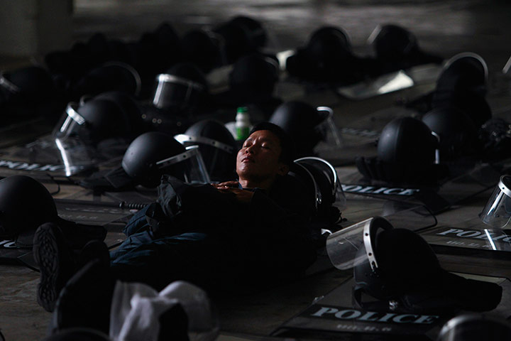 Picture Desk Live: Thai riot policeman rests at Constitution Court in Bangkok