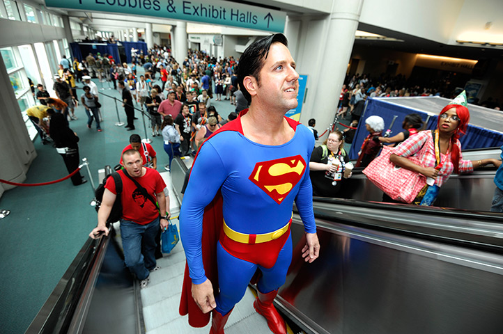 Comic con: Trey Moore, dressed as Superman, rides the escalator