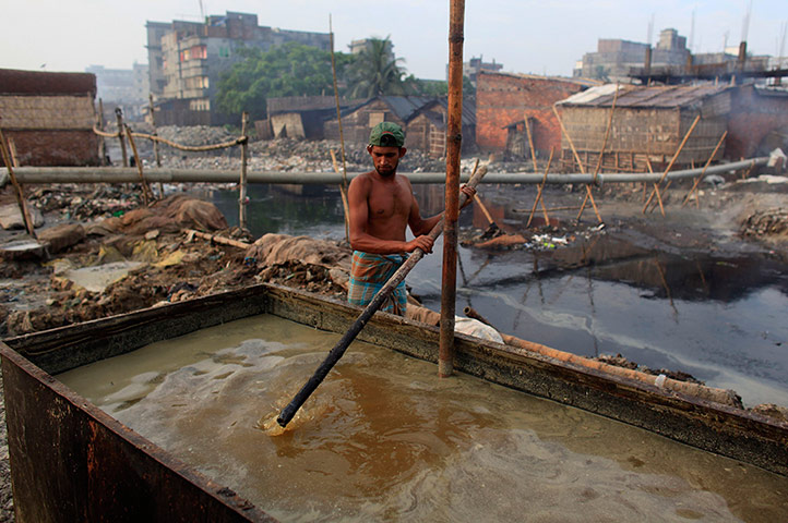 24 Hours: Dhaka, Bangladesh: A man processes tannery waste in Hazaribagh