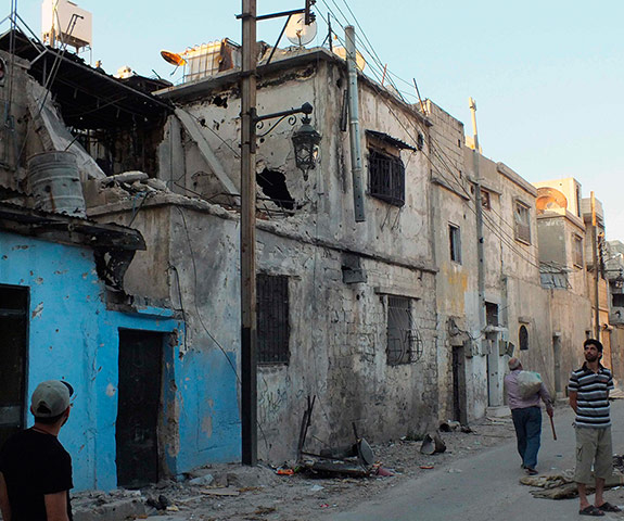Picture Desk Live: Residents inspect the destruction in Bab-Todmor in Homs
