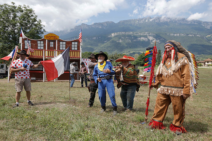 Picture Desk Live: Disguised spectators wait for the riders to pass during the Tour de France 