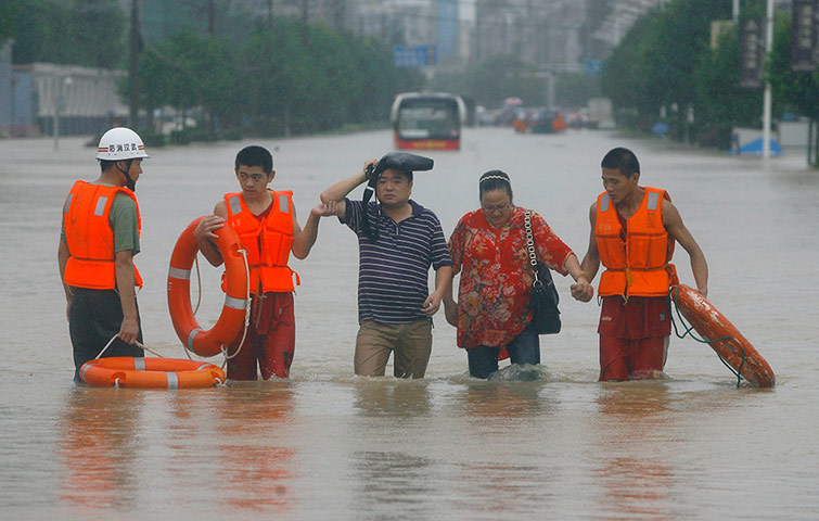 A Longer View - Flooding: Rescuers evacuate residents to a safer area 