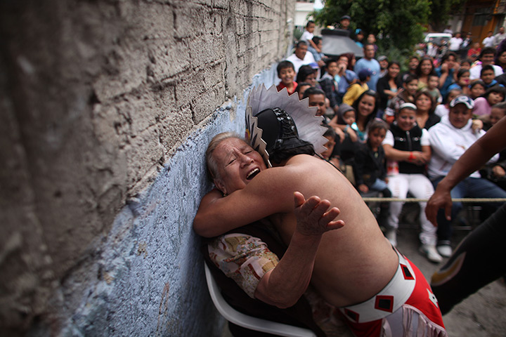 Lucha Libre, Mexico: Lucha Libre wrestler Mixteco Jr., hugs a woman