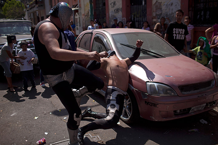 Lucha Libre, Mexico: Wrestlers Brazo de Plata Junior (L) and Shadow perform outside the ring