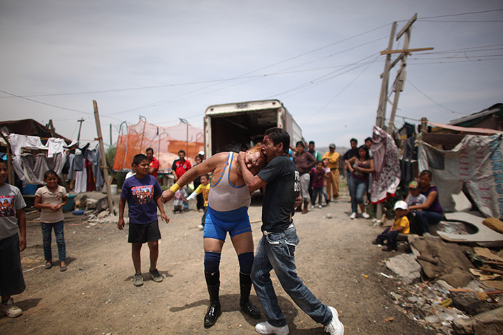 Lucha Libre, Mexico: Lucha Libre wrestler Super Tarin, right, bites the forehead of Leon Dorado