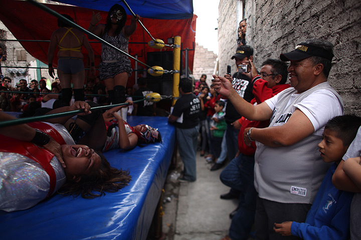 Lucha Libre, Mexico: Fans watch as watch Mexican Lucha Libre wrestlers are beaten