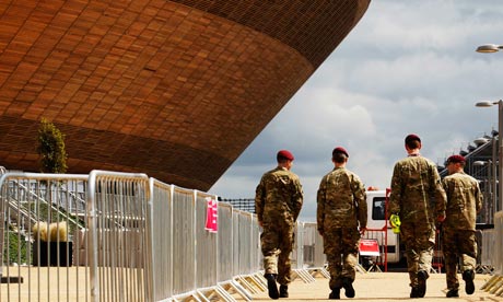 Soldiers walk past the Velodrome at the Olympic Park in Stratford