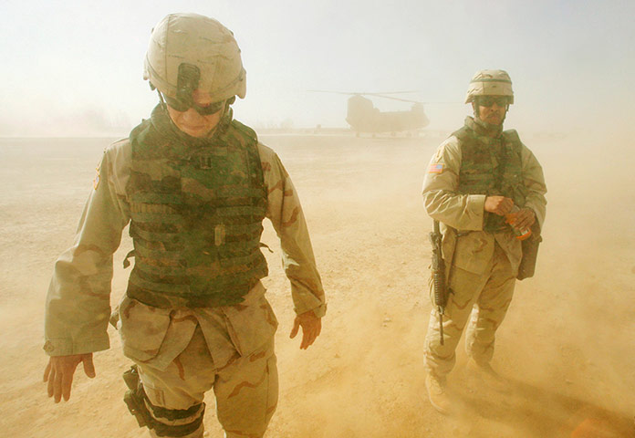 US Army Camouflage: U.S army soldiers stand in sand 