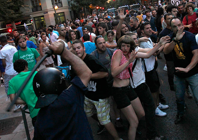 24 hours: A riot police officer hits demonstrators in Madrid