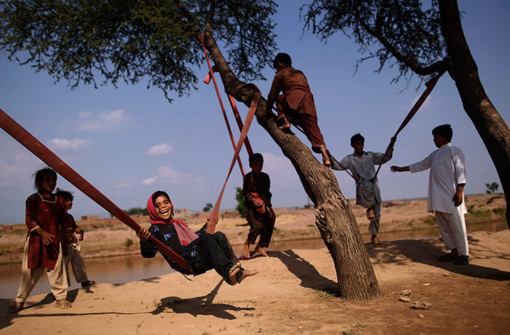 24 hours: Children play on rope swings 