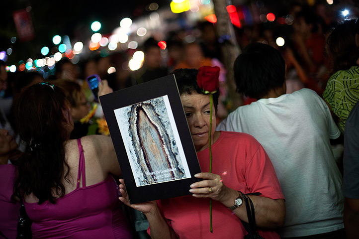 24 hours: West New York, New Jersey, US: A woman holds a picture of a tree with scar