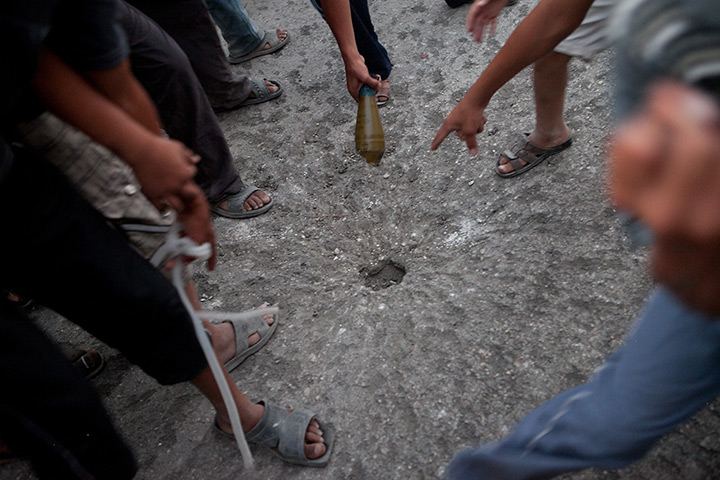 Tremseh, Syria: Syrians point to the spot where a shell fell 