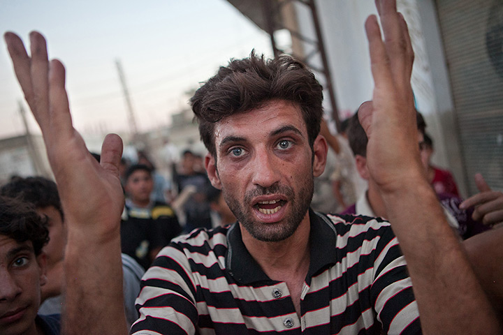 Tremseh, Syria: A resident of Tremseh shouts slogans