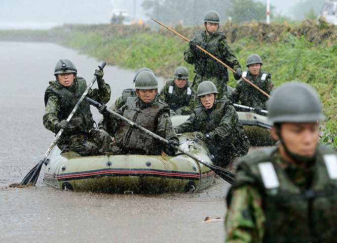 Floods in Japan: Self-Defence Force soldiers search for missing people in Aso