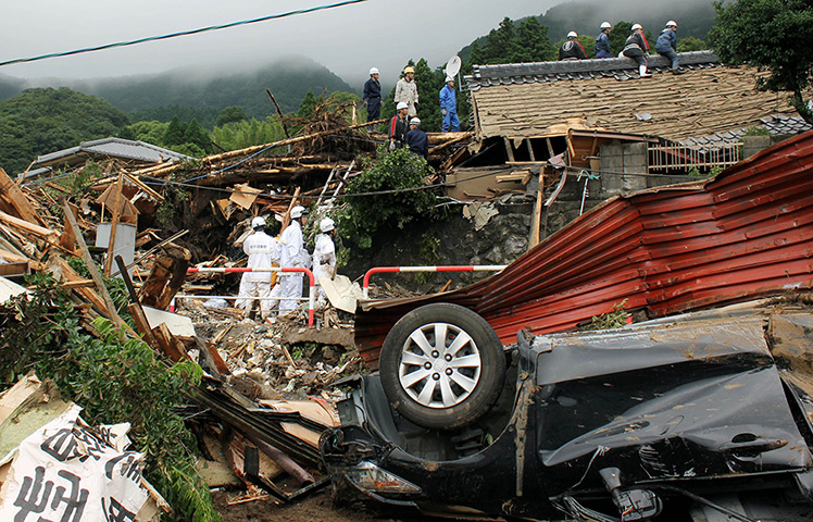 Floods in Japan: Police officers search for missing villagers after a mudslide in Minamiaso