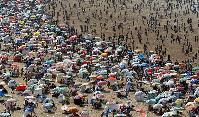 24 hours: Rabat , Morocco: A crowd of people gather at the beach during a heat wave 