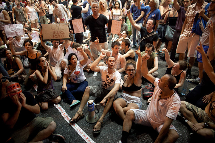 Tel Aviv protests: Israelis sit in the streets as their protest blocks a highway