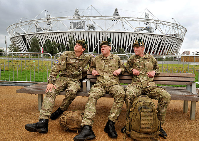 Picture desk live: soldiers from Scotland rest in front of the Olympic stadium