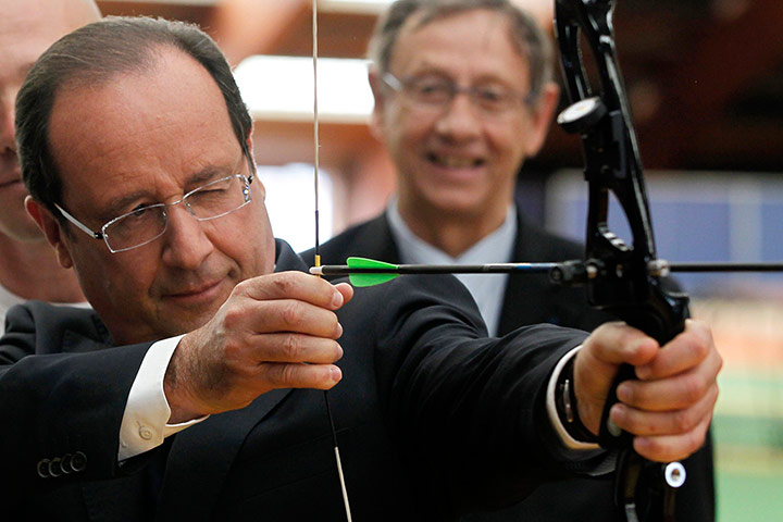 Picture desk live: Francois Hollande takes aim on a visit to meet France's 2012 Olympic team