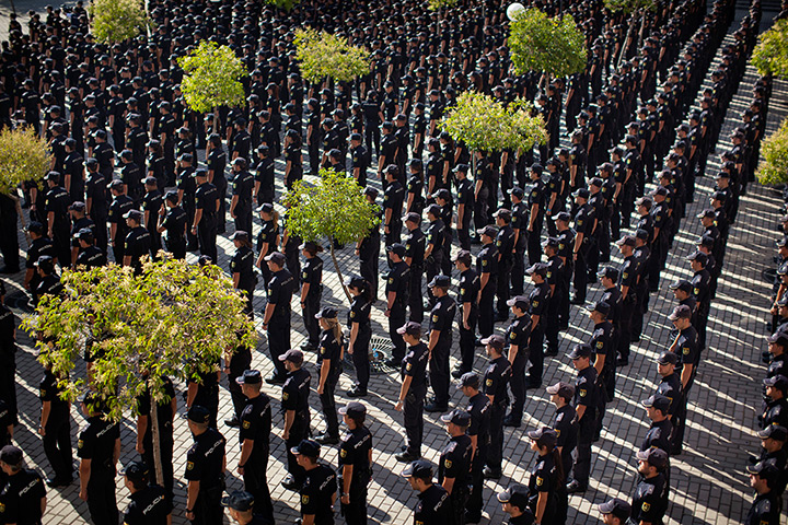24 hours: Madrid, Spain: Police cadets attend a graduation ceremony