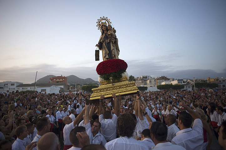 24 hours: Malaga, Spain: Penitents take part in the Virgen del Carmen procession
