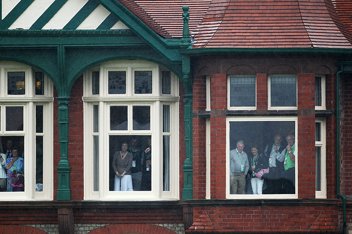 Lee Westwood: Members look out over a rainy 18th green 