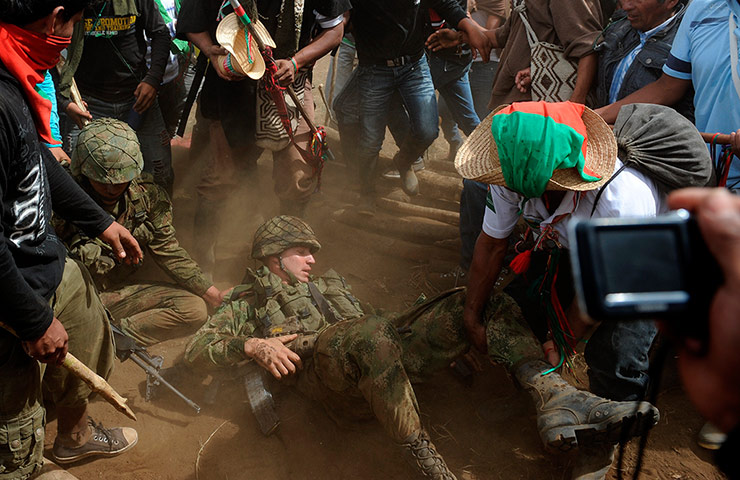 Picture Desk Live: Indigenous natives drag Colombian army officer from his post