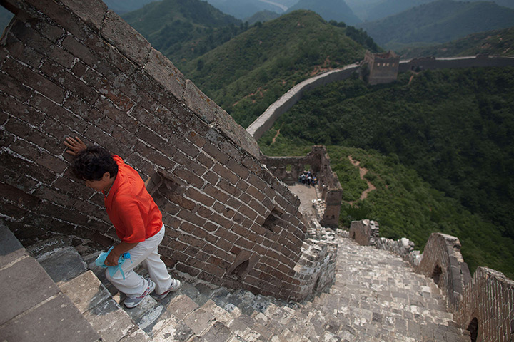 24 hours: Hebei province, China: A woman climbs part of the Great Wall of China