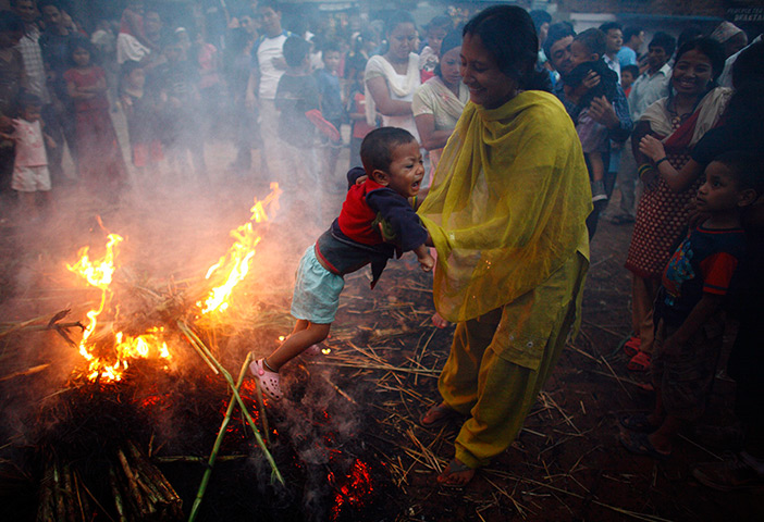 24 hours: Bhaktapur, Neal: A boy cries as his mother swings him around the fire 