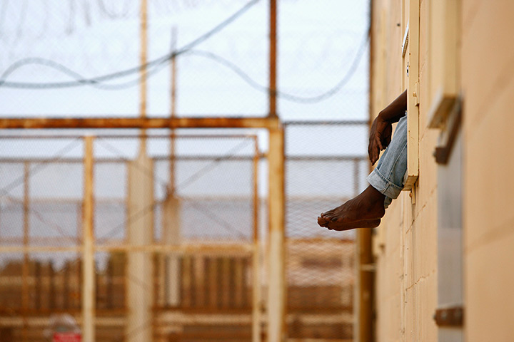 24 hours: Safi, Malta: An African illegal immigrant's feet dangle through the window 