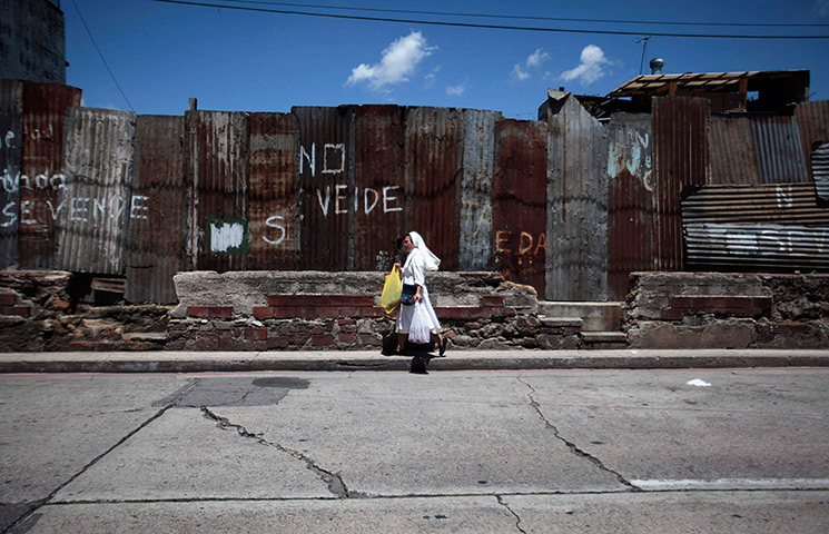 24 hours: Guatemala City, Guatemala: A nun walks along a street