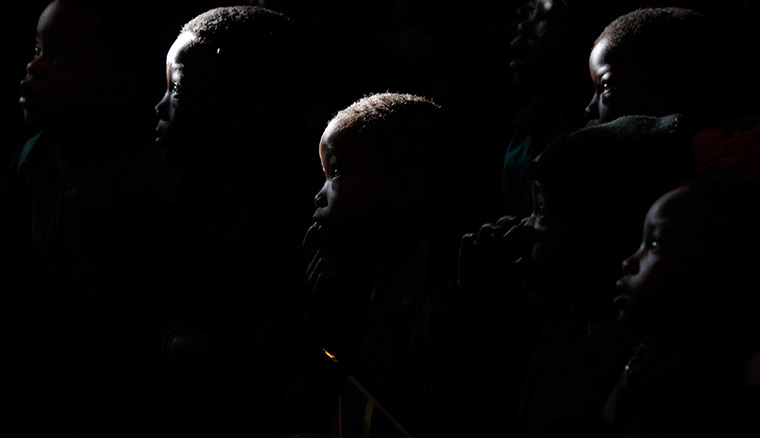 24 hours: Johannesburg, South Africa: Children listen to a history of Nelson Mandela