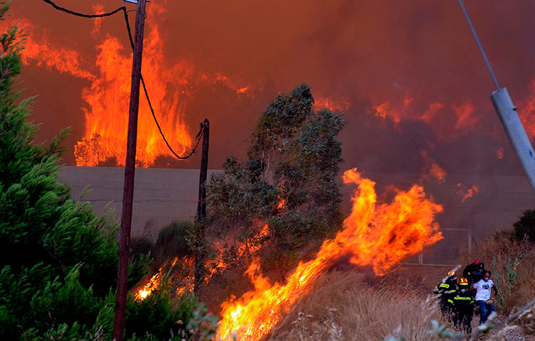 Picture Desk Live: Residents are evacuated by firemen as a