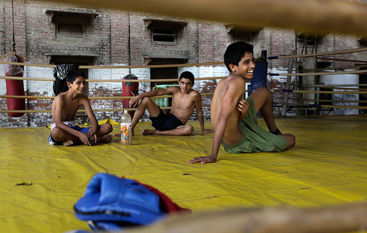 Boxing in India: Indian boxers relax in the ring after a training session 