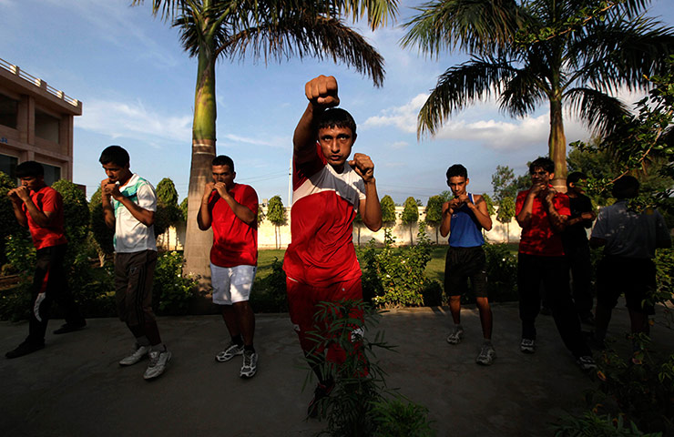 Boxing in India: Indian amateur boxers from Bhiwani Boxing Club practice shadow boxing