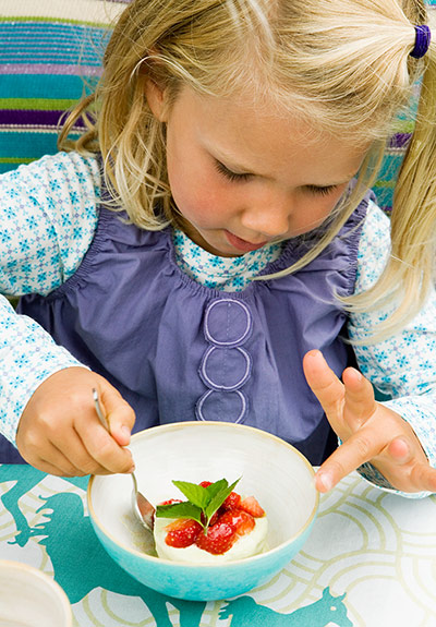 Brita food: Youg girl eating ice-cream dessert