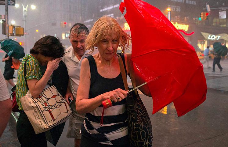 Picture desk live: Commuters in New York make their way through a thunderstorm