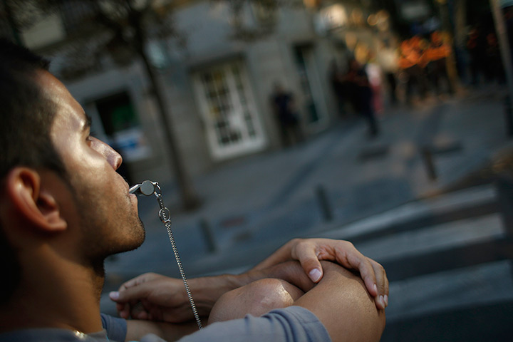  24 hours: Madrid, Spain: A demonstrator blows a whistle during a protest