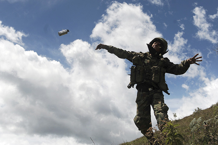 Civil unrest in Colombia: A Colombian soldier throws a tear gas cannister in Mount Berlin, Toribio