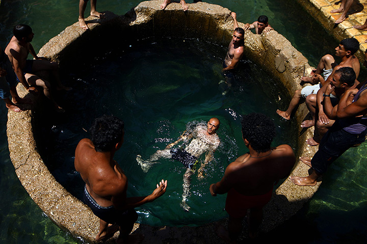  24 hours: West Bank: Israelis and Palestinians cool themselves at the Ein Fuar spring