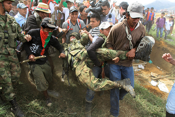 Civil unrest in Colombia: Nasa Indians drag a soldier during an attack on soldiers guarding the tower