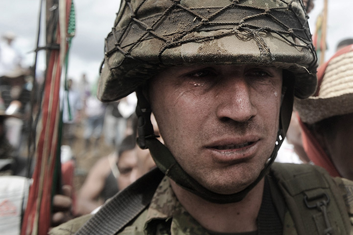 Civil unrest in Colombia: Colombian  army sergeant Rodrigo Garcia leaves with tears in his eyes