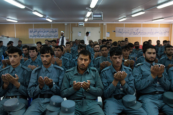  24 hours: Jalalabad, Afghanistan: Newly graduated national police officers pray