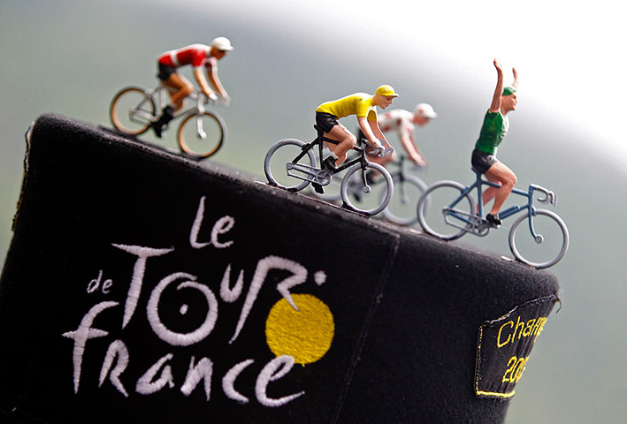 stage 17: Toys figurines representing leader's jersey riders are seen on hat