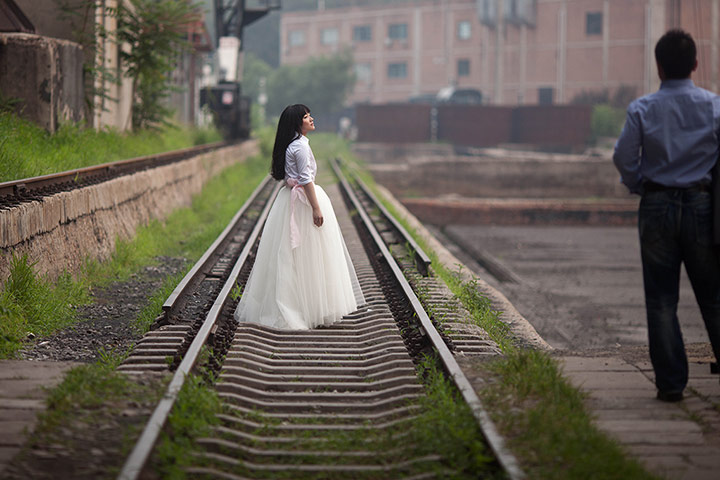 Picture desk live: A bride poses for photos on disused railway tracks in Beijing