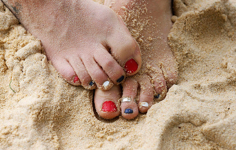 Picture desk live: British beach volleyball player Mullin's painted toess are seen in training