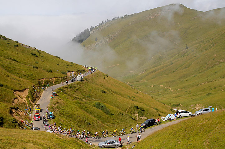 tour stage 17: The riders climb out of the fog on the Port de Bales 