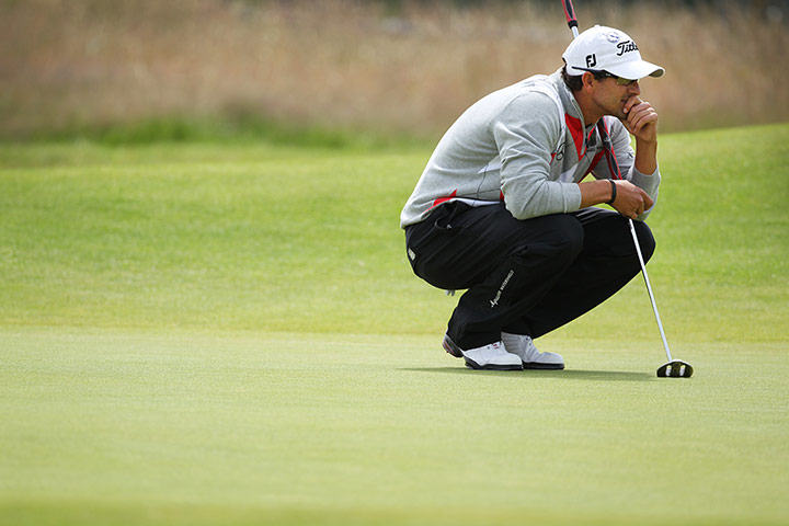 Open Golf day 1: Scott eyes up his putt on the 18th