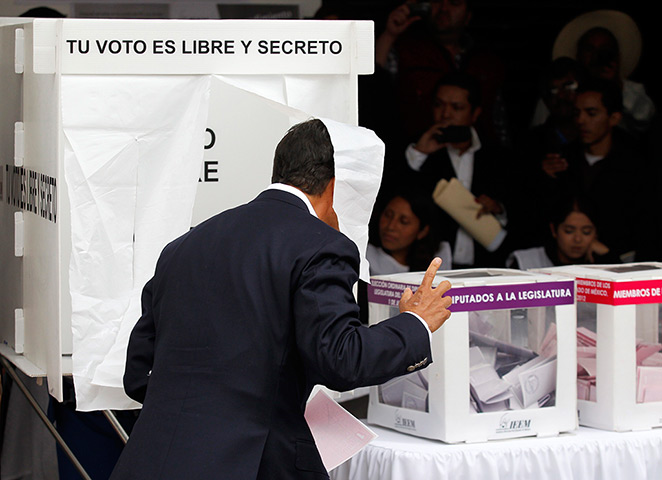 Mexico elections: Enrique Pena Nieto comes out of the polling booth in Atlacomulco